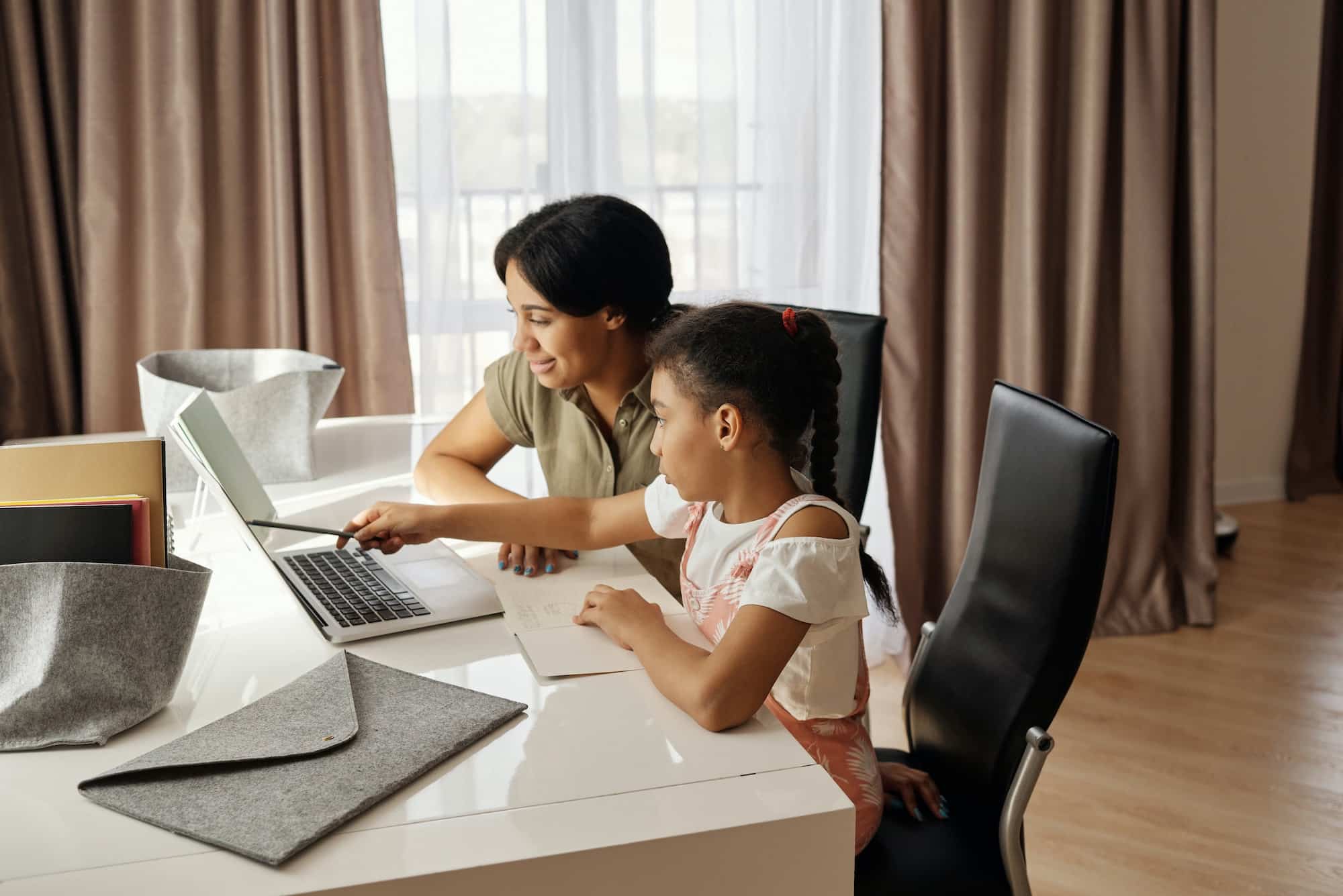 mother and child looking at a computer.